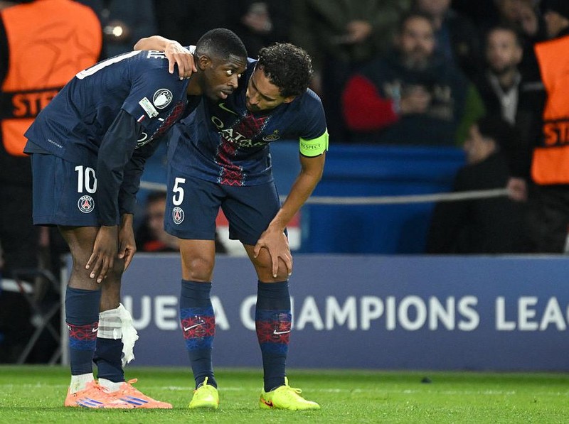 PARIS, FRANCE - NOVEMBER 4: PSG’s Ousmane Dembélé is comforted by teammate Marquinhos following an injury during the UEFA Champions League 2025/26 League Phase MD4 match between Paris Saint-Germain and FC Bayern München at Parc des Princes on November 4, 2025 in Paris, France. (Photo by Lionel Hahn/Getty Images)