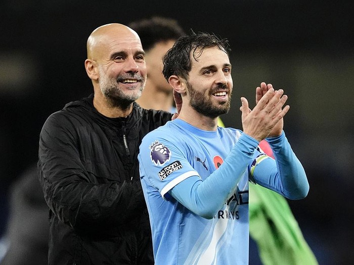 Manchester City's Bernardo Silva (right) and manager Pep Guardiola applaud the fans following victory in the Premier League match at Etihad Stadium, Manchester. Picture date: Sunday November 9, 2025. (Photo by Nick Potts/PA Images via Getty Images)