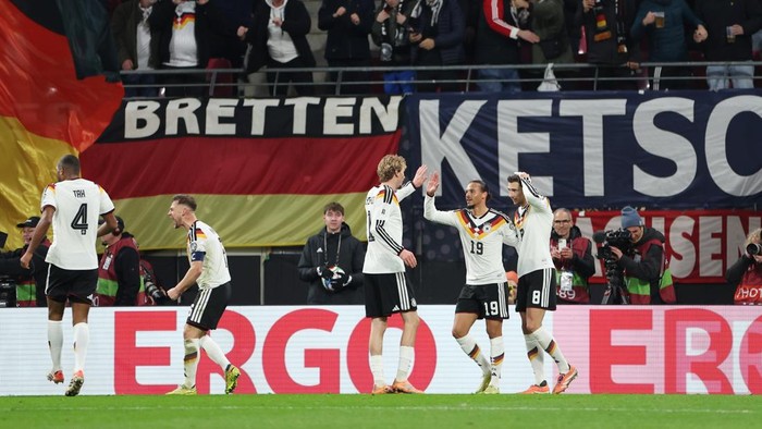 LEIPZIG, GERMANY - NOVEMBER 17: Leroy Sane of Germany celebrates scoring his teams fourth goal with team mates Leon Goretzka and Nick Woltemade during the FIFA World Cup 2026 qualifier match between Germany and Slovakia at Red Bull Arena on November 17, 2025 in Leipzig, Germany. (Photo by Boris Streubel - UEFA/UEFA via Getty Images)