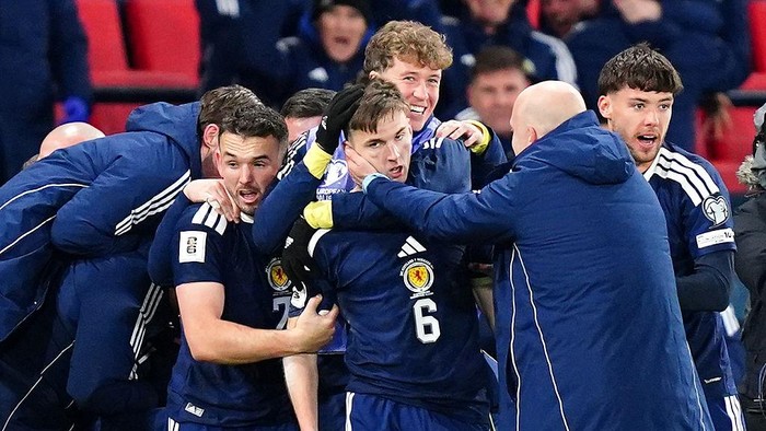 Scotlands Kieran Tierney (centre) celebrates scoring their sides third goal of the game with team-mates during the FIFA World Cup European Qualifying match at Hampden Park, Glasgow. Picture date: Tuesday November 18, 2025. (Photo by Jane Barlow/PA Images via Getty Images)