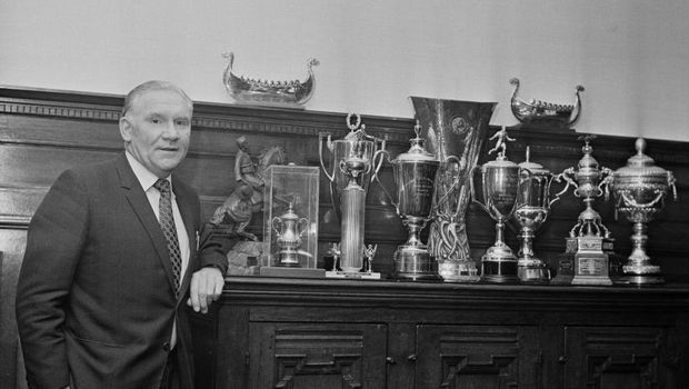 English former football player Bill Nicholson (1919 - 2004), manager of Tottenham Hotspur FC, with Spurs' trophies and awards, London, UK, 3rd March 1973. (Photo by Norman Quicke/Daily Express/Hulton Archive/Getty Images)