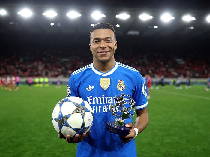 PIRAEUS, GREECE - NOVEMBER 26: Kylian Mbappe of Real Madrid poses for a photo with the match ball and the 