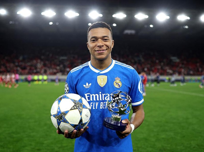 PIRAEUS, GREECE - NOVEMBER 26: Kylian Mbappe of Real Madrid poses for a photo with the match ball and the 