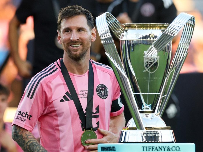 Dec 6, 2025; Fort Lauderdale, Florida, USA; Inter Miami forward Lionel Messi (10) looks on with the Philip F. Anschutz trophy after winning the 2025 MLS Cup against the Vancouver Whitecaps FC at Chase Stadium. Mandatory Credit: Nathan Ray Seebeck-Imagn Images
