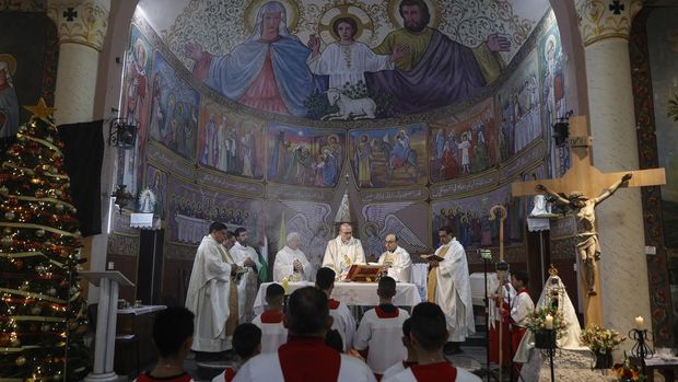 Cardinal Pierbattista Pizzaballa (C), Latin Patriarch of Jerusalem, leads a Christmas Mass at the Holy Family Parish during his visit to Gaza City on December 21, 2025. Pizzaballa arrived in Gaza on December 19 for Christmas Mass at the Holy Family Parish in Gaza City, which hosts the Palestinian territory's only Roman Catholic church. The Latin Patriarchate says 135 Catholics live in Gaza. They sought shelter inside the compound of the Holy Family Church in the first days of the war between Israel and Hamas. (Photo by Omar AL-QATTAA / AFP)