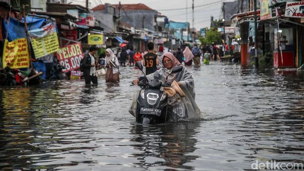 Aksi Nekat Warga Dorong Motor di Tengah Banjir Pondok Ungu Permai Bekasi