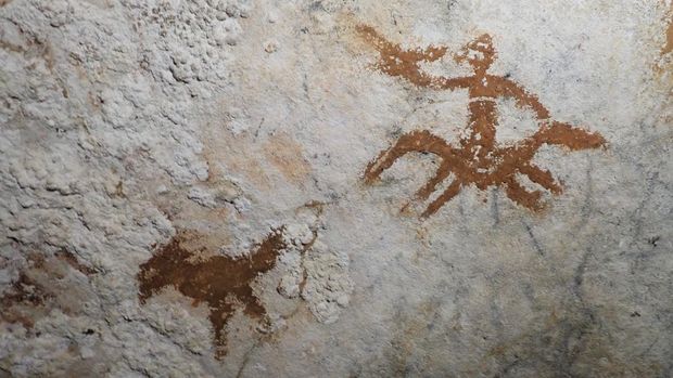 This handout photograph released by Griffith University's Maixme Aubert on January 21, 2026, shows a view of prehistoric cave paintings in the Sulawesi island of Indonesia. In the caves of Sulawesi, Indonesia, researchers have discovered slender stenciled hands with deliberately elongated, claw-like fingernailsthe oldest example of rock art in the world, dating back 67,800 years. (Photo by Maxime AUBERT / GRIFFITH UNIVERSITY / AFP)