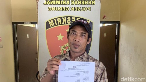 Warga bernama Burhanuddin menunjukkan surat Tanda Bukti Laporan Pengaduan (TBLP) seusai membuat laporan di Polsek Gerung, Kamis (5/2/2026). (Foto: M Zahiruddin/detikBali)