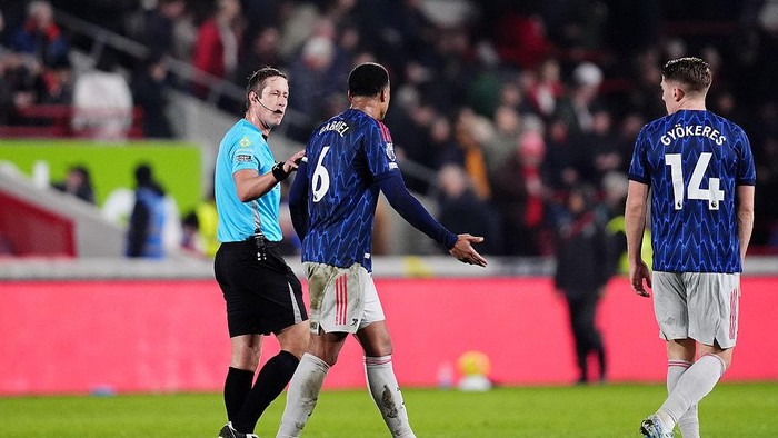 Arsenals Gabriel (centre) speaks to referee John Brooks (left) at half-time during the Premier League match at the Gtech Community Stadium, London. Picture date: Thursday February 12, 2026. (Photo by John Walton/PA Images via Getty Images)