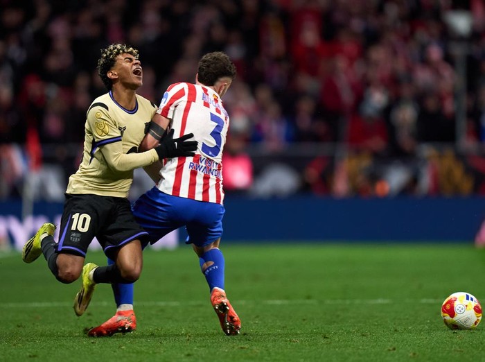 MADRID, SPAIN - FEBRUARY 12: Lamine Yamal of FC Barcelona clashes with Matteo Ruggeri of Atletico de Madrid during the Copa Del Rey Semi-Final First Leg match between Atletico de Madrid and FC Barcelona at Riyadh Air Metropolitano on February 12, 202