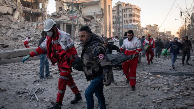 In this picture obtained from Iran's ISNA news agency on March 3, 2026, rescue workers carry the body of a victim after a strike on a building in Tehran's Enghelab Square. Iran's Revolutionary Guards said on March 4, they had total control of the Strait of Hormuz, a key waterway for global energy transit, as Israel launched a new wave of strikes on the Iranian capital. (Photo by MAJID KHAHI / ISNA / AFP)