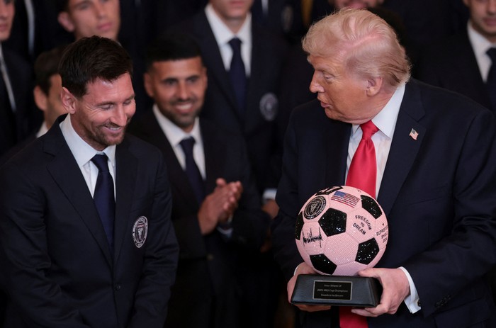 U.S. President Donald Trump arrives with Inter Miami CF captain Lionel Messi on the day he honors reigning Major League Soccer (MLS) champion Inter Miami CF players and team officials with an event in the East Room of the White House in Washington, D