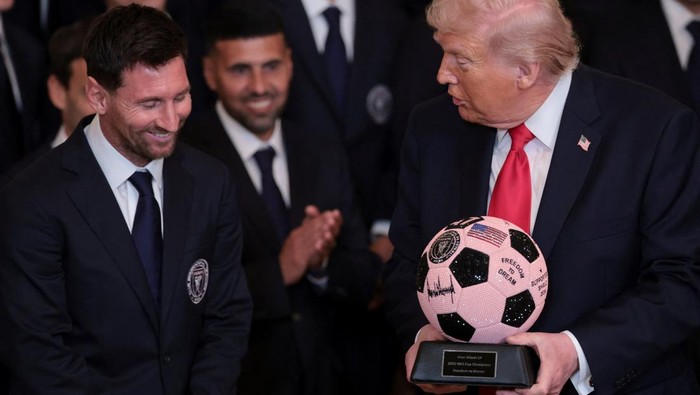 U.S. President Donald Trump arrives with Inter Miami CF captain Lionel Messi on the day he honors reigning Major League Soccer (MLS) champion Inter Miami CF players and team officials with an event in the East Room of the White House in Washington, D