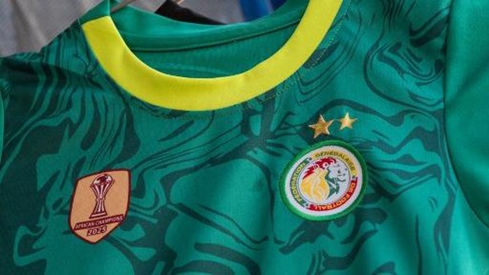 A general view of a shirt, featuring the second star symbolising their second victory in the Africa Cup of Nations final against Morocco, at a shop selling Senegal national team shirts in the Almadies district of Dakar on March 18, 2026. Senegal foot