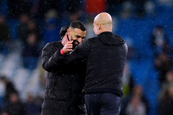 Manchester City manager Pep Guardiola (right) with Liverpools Mohamed Salah following the Premier League match at the Etihad Stadium, Manchester. Picture date: Sunday February 23, 2025. (Photo by Martin Rickett/PA Images via Getty Images)