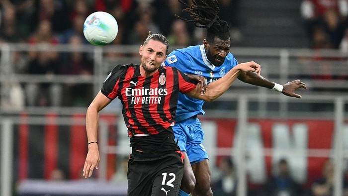 MILAN, ITALY - SEPTEMBER 28: Adrien Rabiot of AC Milan and  André-Frank Zambo Anguissa of SSC Napoli compete for the ball during the Serie A match between AC Milan and SSC Napoli at Giuseppe Meazza Stadium on September 28, 2025 in Milan, Italy. (Pho
