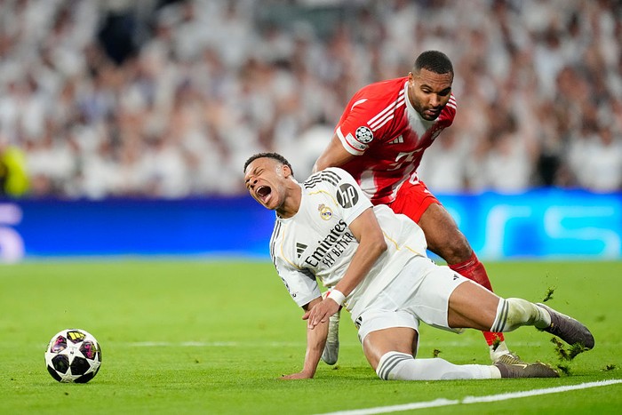 Kylian Mbappe centre-forward of Real Madrid and France and Jonathan Tah centre-back of Bayern Munchen and Germany compete for the ball during the UEFA Champions League 2025/26 Quarter-Final First Leg match between Real Madrid CF and FC Bayern Münche