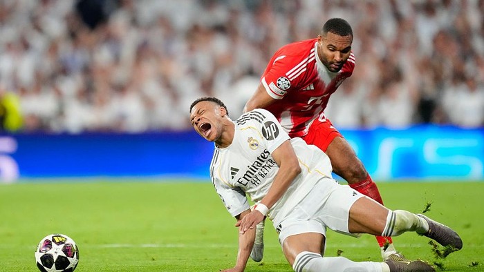 Kylian Mbappe centre-forward of Real Madrid and France and Jonathan Tah centre-back of Bayern Munchen and Germany compete for the ball during the UEFA Champions League 2025/26 Quarter-Final First Leg match between Real Madrid CF and FC Bayern Münche