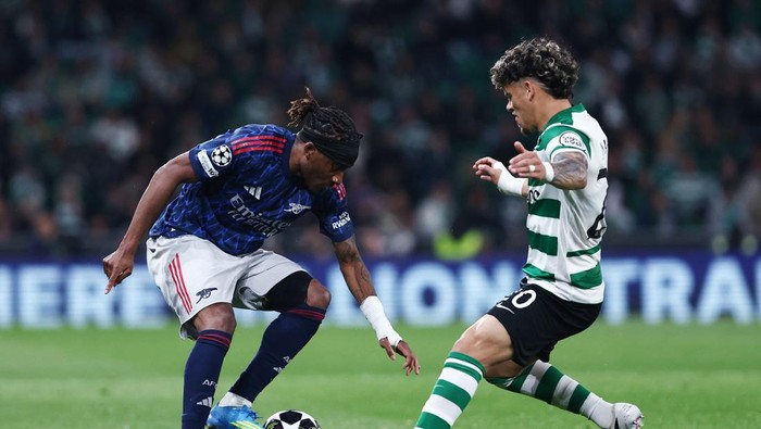 Soccer Football - UEFA Champions League - Quarter Final - First Leg - Sporting CP v Arsenal - Estadio Jose Alvalade, Lisbon, Portugal - April 7, 2026 Arsenals Noni Madueke in action with Sporting CPs Maximiliano Araujo REUTERS/Rodrigo Antunes