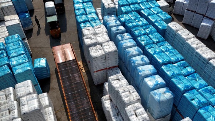 An employee works at an assembly line producing car smartphone holders at a plastic accessories factory, as rising oil prices drive up production costs for plastic manufacturers, in Dongguan, Guangdong province, China, April 2, 2026.  REUTERS/Go Nakamura