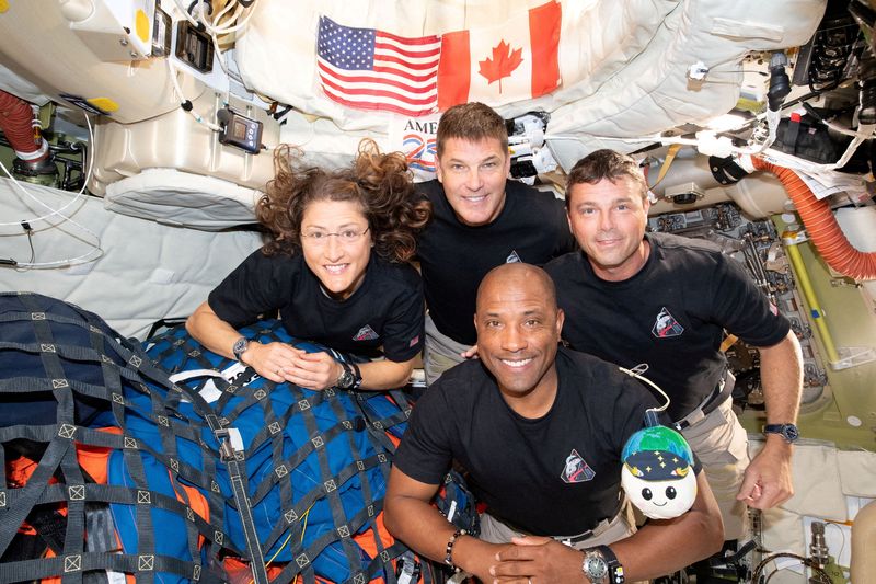The NASA Artemis II crew, Mission Specialist Christina Koch, Mission Specialist Jeremy Hansen, Commander Reid Wiseman, and Pilot Victor Glover, pose for a group photo inside the Orion spacecraft on their way home following a flyby of the far side of the Moon on April 6, 2026. NASA/Handout via REUTERS THIS IMAGE HAS BEEN SUPPLIED BY A THIRD PARTY. REFILE - CORRECTING DATE FROM 