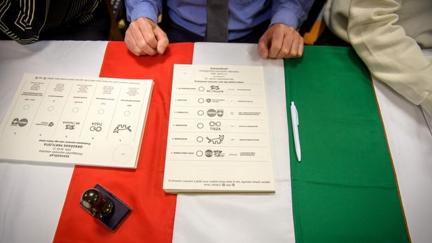 Ballot papers are placed on a Hungarian flag at a polling station in Budapest at the start of a general election in Hungary, on April 12, 2026. The vote could end Hungarian Prime Minister Viktor Orban's 16-year stint in power as the EU's longest serving current leader and a self-decribed 