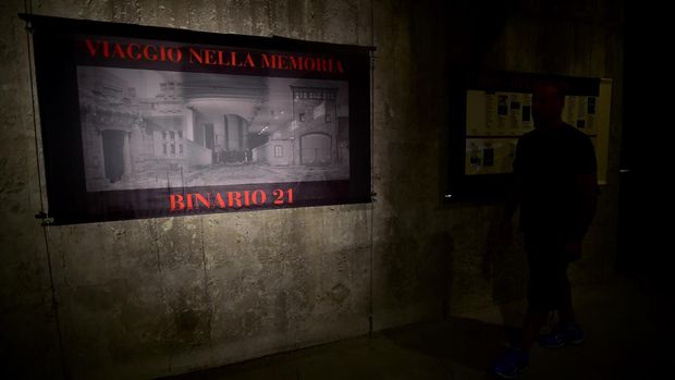 A migrant walks in the Shoah Museum - Binario 21 ('Platform 21') at the Central Station in Milan on July 1, 2015, where migrants seek shelter and where beds, food and showers are provided each night. AFP PHOTO / GIUSEPPE CACACE (Photo by GIUSEPPE CACACE / AFP)