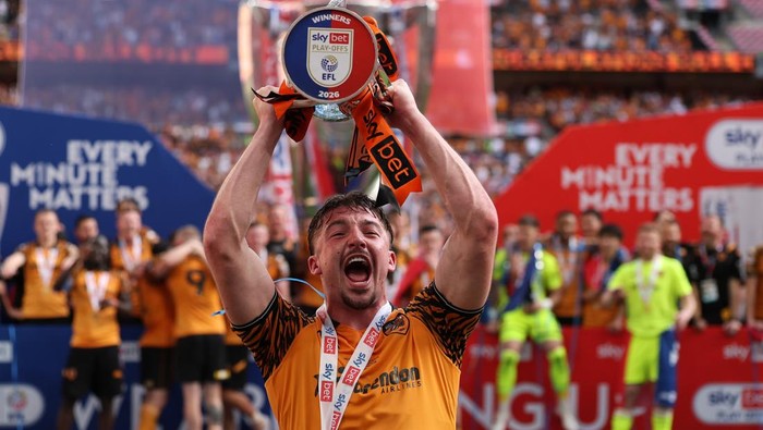LONDON, ENGLAND - MAY 23: Charlie Hughes of Hull City celebrates with the Sky Bet Championship Play-Off Final trophy after his teams victory in the Sky Bet Championship Final match between Hull City and Middlesbrough at Wembley Stadium on May 23, 
