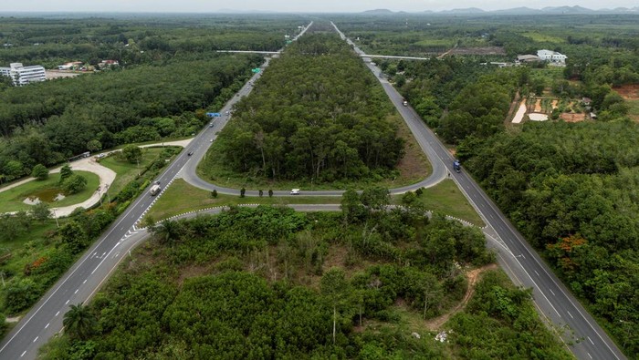 Proyek Raksasa Thailand Bidik Arus Logistik Dunia, Saingi Selat Malaka A drone view shows Highway 44, also known as the Southern Seaboard Highway, a route linking Krabi and Surat Thani provinces, as part of Thailand’s proposed Southern Land Bridge project to connect the Andaman Sea and the Gulf of Thailand, in Surat Thani province, Thailand, May 21, 2026. REUTERS/Chalinee Thirasupa