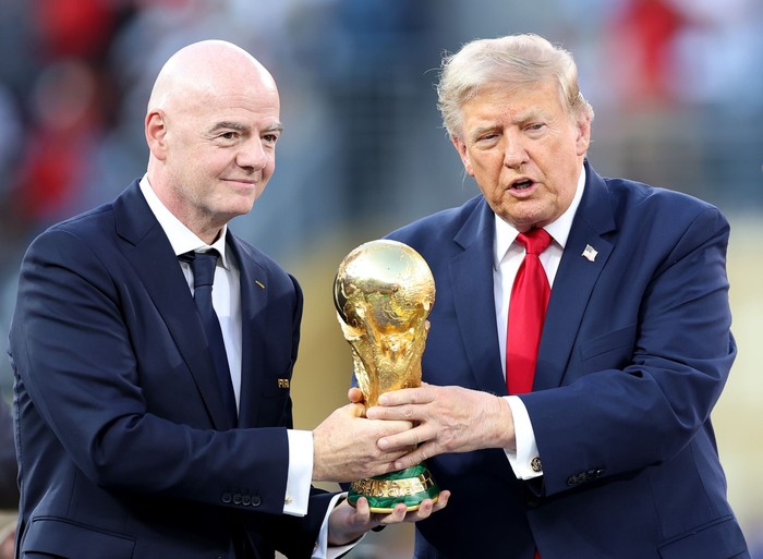 EAST RUTHERFORD, NEW JERSEY - JULY 19: U.S. President Donald Trump and FIFA President Gianni Infantino hold the FIFA World Cup Winners Trophy before handing over to captain Rodri #16 of Spain at the award ceremony following the FIFA World Cup 2026 F