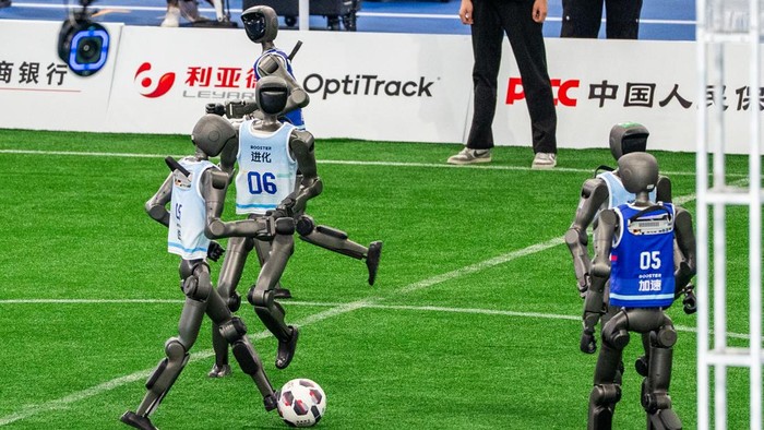 BEIJING, CHINA - AUGUST 22: Humanoid robots plays football during the opening ceremony of the 2nd World Humanoid Robot Games at the National Speed Skating Oval on August 22, 2026 in Beijing, China. (Photo by VCG/VCG via Getty Images)