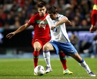 Miguel Veloso mengawal pergerakan Zvijezdan Misimovic dalam laga yang digelar di Estadio da Luz, Portugal. Reuters/Jose Manuel Ribeiro.