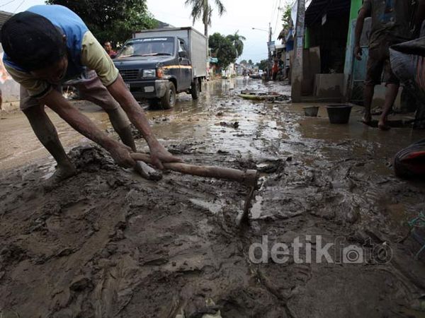 Warga Bersihkan Lumpur Sisa Banjir