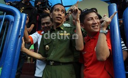 Gubernur DKI Jakarta Joko Widodo (tengah) didampingi Ketua Umum Persija Jakarta Ferry Paulus (kanan), memasuki Lapangan Banteng, Jakarta, untuk menemui para pemain dan pelatih tim sepakbola Persija.