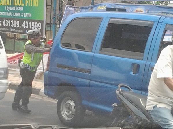 Sendirian, Polisi Ini Dorong Mobil Mogok