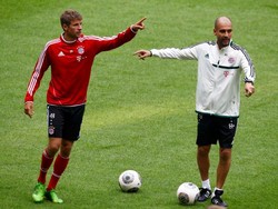 Guardiola dengan salah satu pemain bintang Bayern, Thomas Mueller, dalam sesi latihan pertama mereka hari Rabu (27/6) kemarin. (REUTERS/Michaela Rehle)