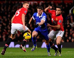 Kevin Mirallas berusaha melewati Nemanja Vidic dan Rafael dalam pertandingan yang dihelat di Old Trafford. AFP/Andrew Yates.