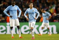Yaya Toure dan David Silva tampak kecewa. Dengan kekalahan ini, City harus memetik kemenangan dengan margin tiga gol tanpa kebobolan saat ganti melawat ke Camp Nou pada 12 Maret mendatang, agar bisa melaju ke babak perempatfinal. Reuters/Darren Staples.