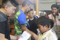 Andhika Suksmana (kiri) dari Footballicious , dan juga Rapahel Maitimo memberi santunan kepada anak-anak kurang mampu ini.