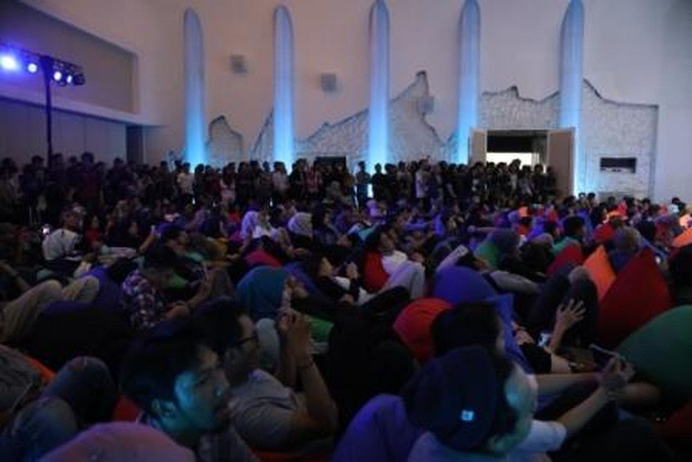 Pendatang yang menonton sambil bersantai diatas bean bag Pendatang yang menonton sambil bersantai diatas bean bag