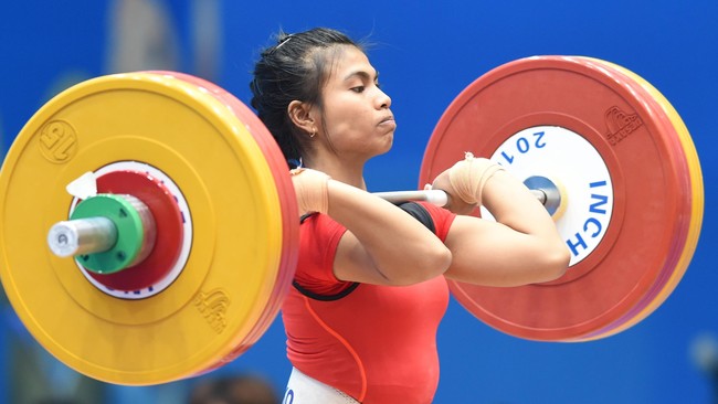 Di usia 22 tahun, Sri Wahyuni akan mengemban beban berat, menjadi andalan Indonesia untuk merebut medali Olimpiade dari cabang angkat besi.