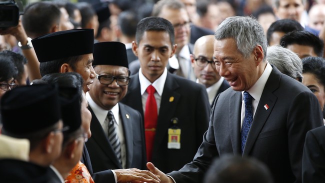 Setelah tiba di Istana Merdeka, Jokowi mulai menyambut sejumlah&nbsp;kepala negara sahabat yang datang. PM Singapura Lee Hsien Long merupakan yang pertama.