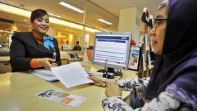 Menko Darmin Pastikan Bunga KUR Turun Meski Tak Instan