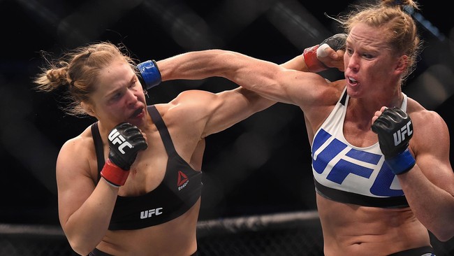 Miesha Tate akan menghadapi Holly Holm pada akhir pekan ini. Lantas, apakah kaitannya dengan Ronda Rousey?