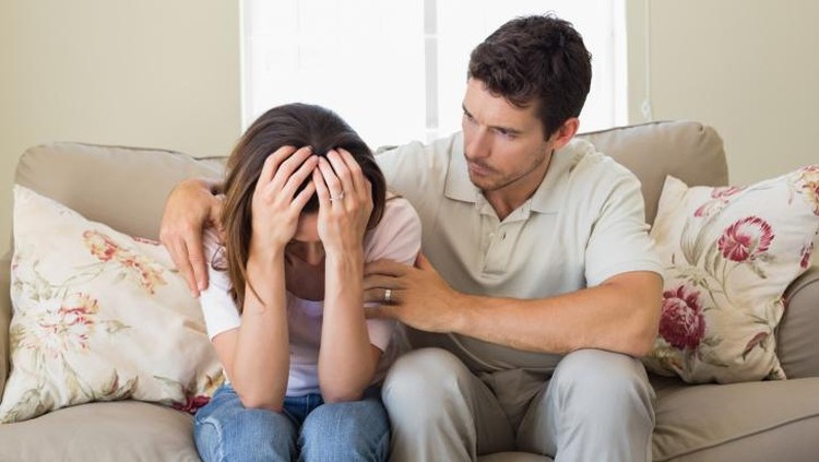 466684610 Man consoling a sad woman in living room