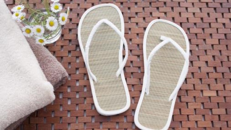 still life of pair of straw flip flops