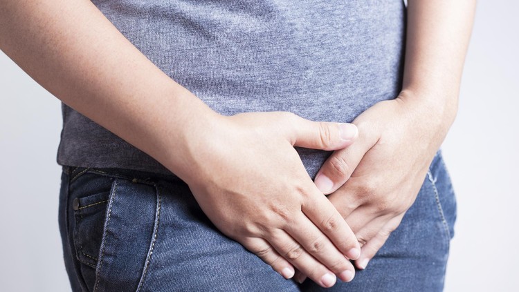 Woman with Hands Holding her Crotch