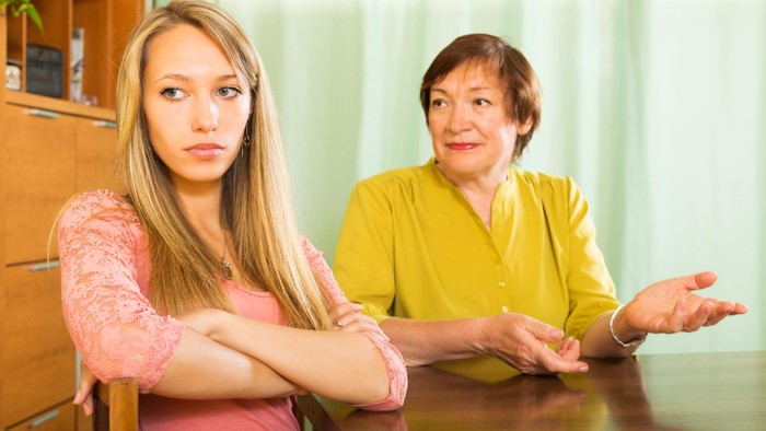 Mature mother and  adult daughter  after quarrel  in home  interior