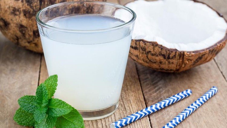 air kelapa coconut water and fresh coconut on wooden background