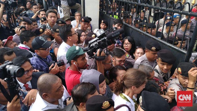 Sekelompok massa yang sejak pagi berada di depan gedung pengadilan semula tak menyadari. Namun karena teriakan awak media, massa bersorak, tangkap Ahok.